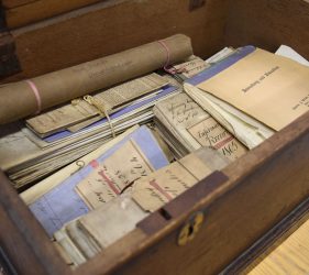 wooden chest containing handwritten documents