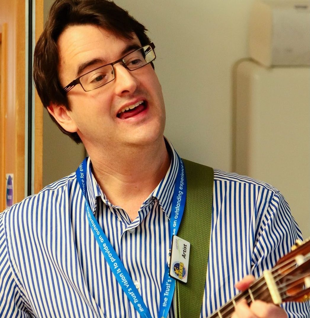 Alex playing guitar, Elevate session, Salisbury District Hospital