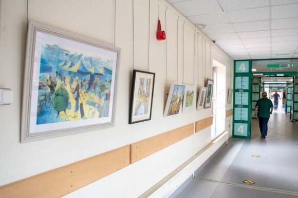 paintings hanging on hospital corridor wall