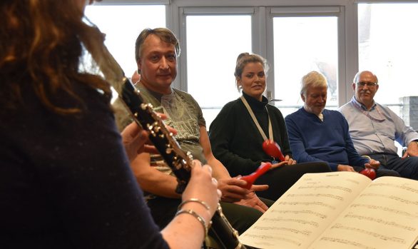 Rosie playing clarinet to Headway group participants