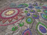 purple, pink blue, green, red and white gravel arranged to from peacock design