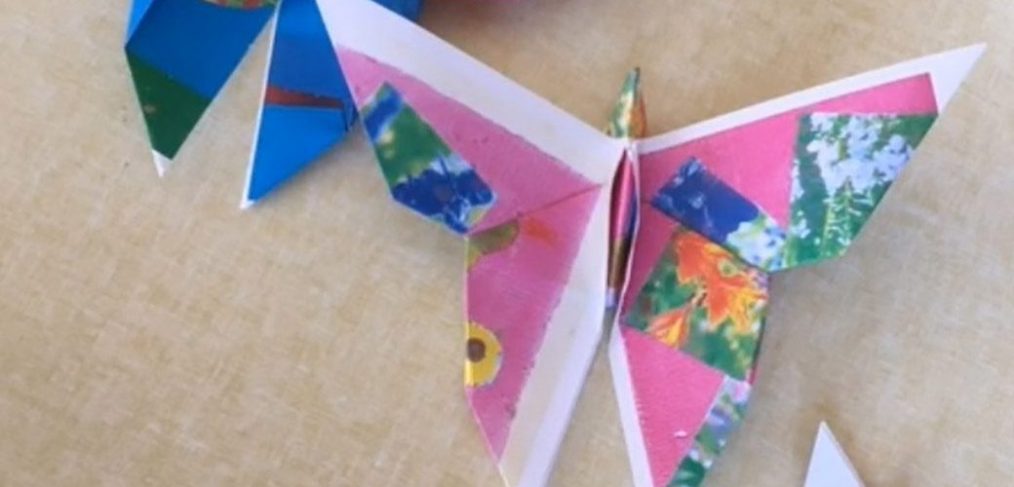 different sized folded paper butterflies in several different coloured papers