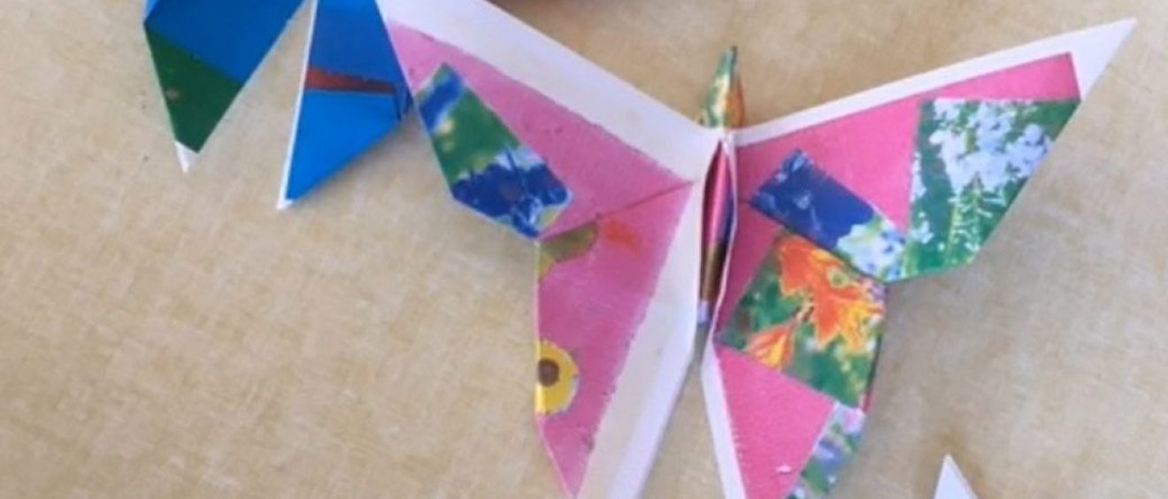 different sized folded paper butterflies in several different coloured papers