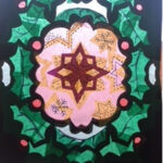 black star, snowflake and tree shapes filled with coloured tissue paper stuck on window