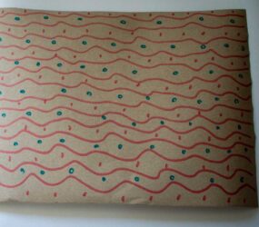 felt tip decorated brown paper with wavy lines and dots