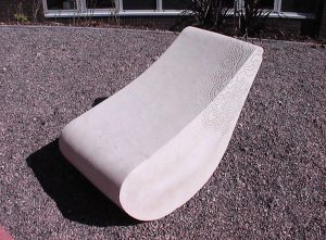 Carved stone seat with surface detail pattern