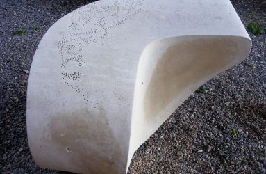 Carved stone seat with surface detail pattern
