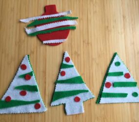 bauble and tree shapes cut out of felt, with coloured felt strips and circles