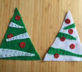running stitch and cross stitch shapes attached to larger felt tree shapes