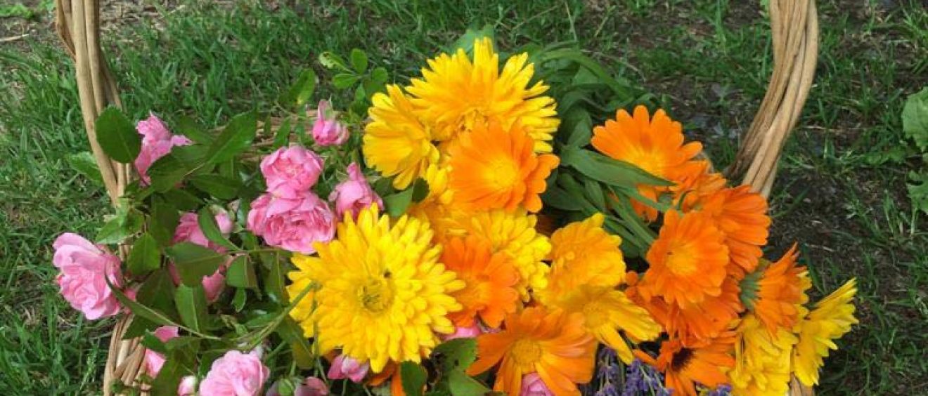 pink roses, lavender, orange marigolds in wicker basket