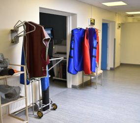 X-ray protection tunics hanging in waiting area with oxygen cylinder