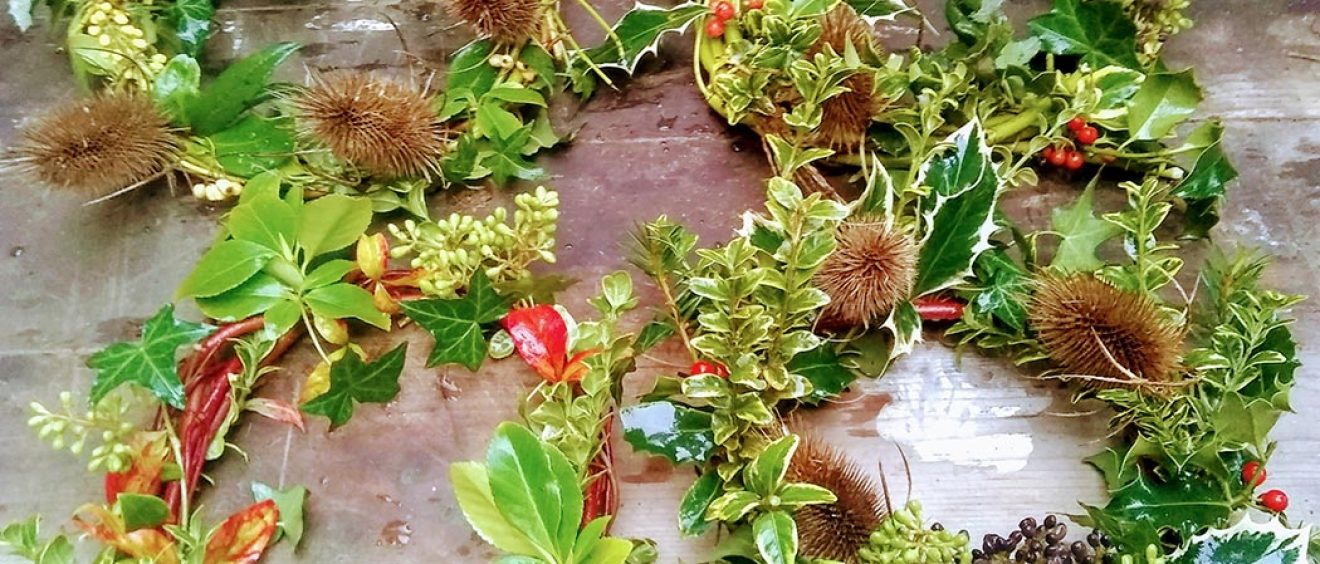 winter wreaths made of holly, leaves, teasel and berries