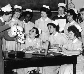 Sister demonstrates to nurses the working of jaw on skull model