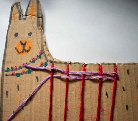 length of ribbon woven through string wound round llama shape
