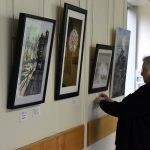 Pam labelling the pictures along the corridor