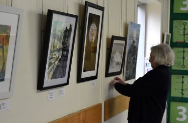 Pam labelling the pictures along the corridor