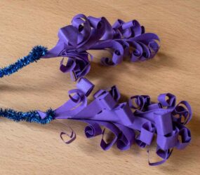 curled card fixed to pipe cleaner to make flower head