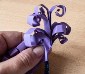 wrapping the curled card around the pipe cleaner