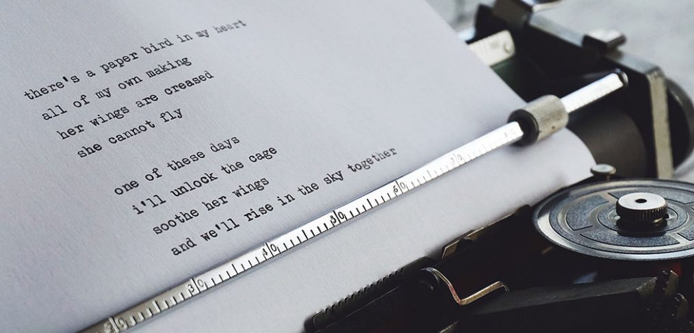 poem being typed on traditional typewriter