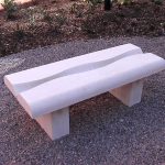 stone bench with a ripple shape and poetry carved along the central length