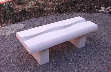 stone bench with a ripple shape and poetry carved along the central length