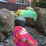 mosaic applied to rock in garden