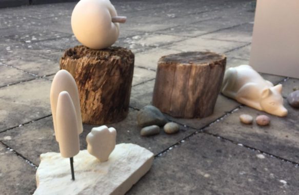 stone apple, fox and abstract tree sculptures