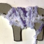 winding purple wool around cardboard sheep template