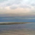 light reflecting off mud flats to create silver colour extending for miles