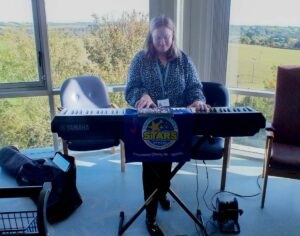 Sophie playing keyboard in bay on ward