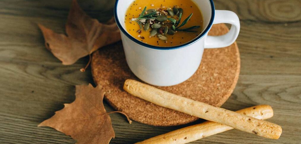 mug of soup and breadsticks