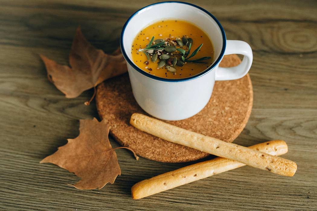 mug of soup and breadsticks