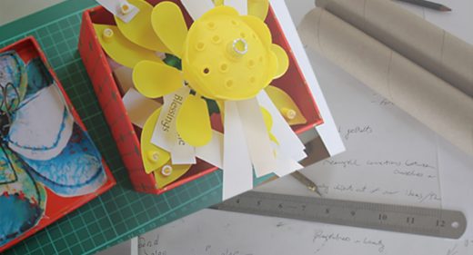 Jottings, pencil, paper and example memory box with words attached to model flower petals
