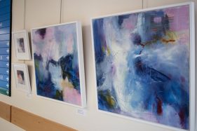 abstract blue and purple canvas hanging on wall